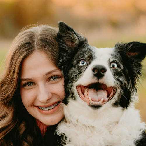 lady carrying her dog happliy looking infront